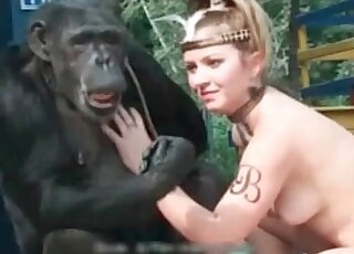 Filthy whore is doing her best to seduce a monkey for sex